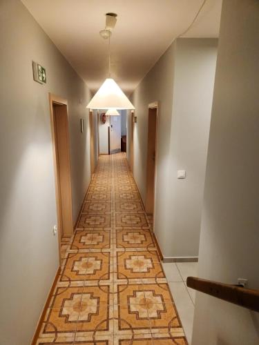a hallway with a tile floor and a ceiling at REKLINIEC in Myślenice