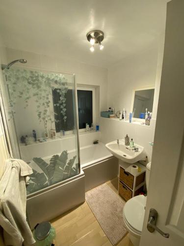 a bathroom with a shower and a sink at Bright Double Room near Lewisham Station in London