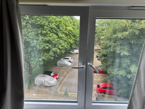a window with a view of a parking lot at Bright Double Room near Lewisham Station in London