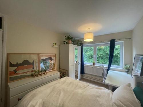 a bedroom with a bed and a window at Bright Double Room near Lewisham Station in London