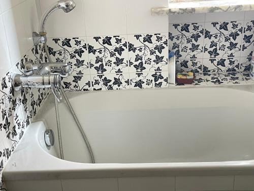 a bath tub with a faucet in a bathroom at Ars in Villa in Livorno