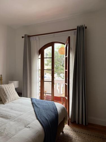 a bedroom with a bed and an open window at Hotel Boutique La Residencia in Lima