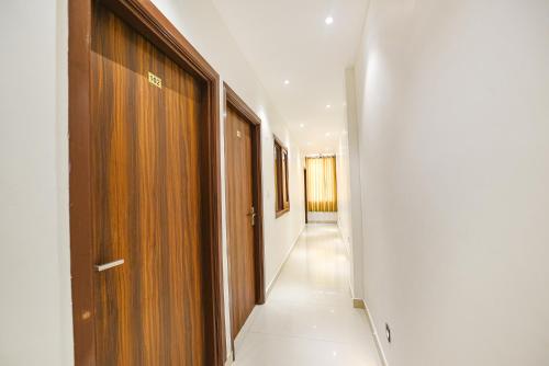 a hallway with wooden doors and a long corridor at SOLACE INN near GOLDEN temple in Amritsar