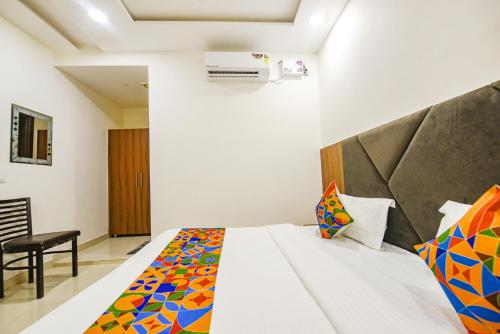 a bedroom with a bed and a chair in a room at SOLACE INN near GOLDEN temple in Amritsar