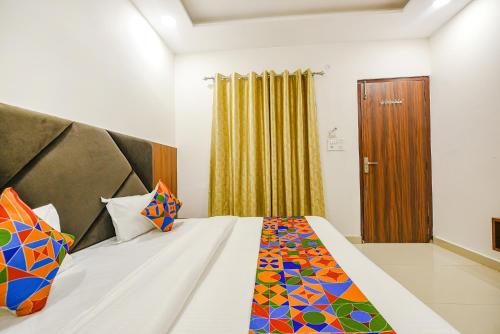 a bedroom with a large bed with colorful pillows at SOLACE INN near GOLDEN temple in Amritsar