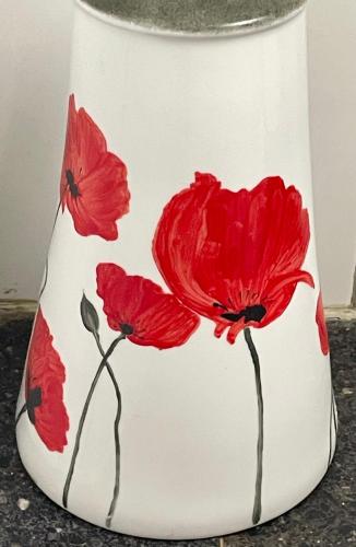a white vase with red flowers painted on it at Ars in Villa in Livorno