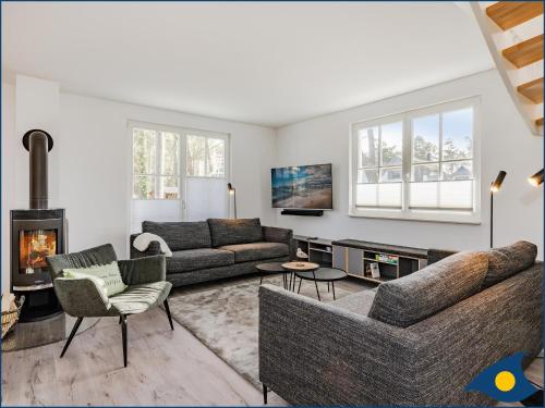 a living room with a couch and a fireplace at Fischerdorf Zirchow Seebär in Zirchow