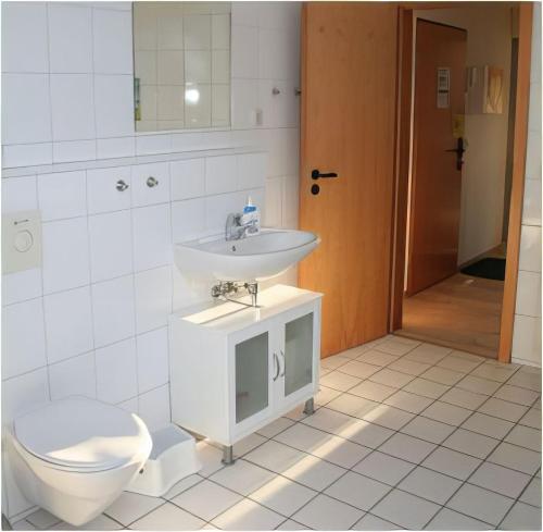 a bathroom with a sink and a toilet at Ferienwohnung - Orther Hafenblick in Orth