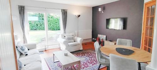 a living room with a table and chairs and a dining room at Orchard Cottages at Gorton House in Roslin