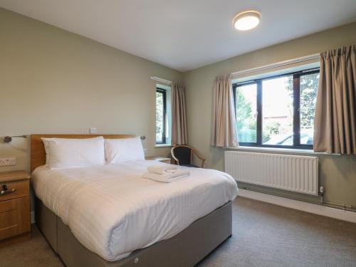 a bedroom with a large bed and a window at The Lifeboat Landing at Marine Court in Littlehampton