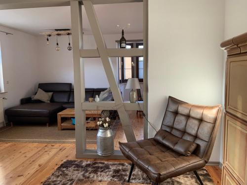a living room with a chair and a mirror at Ferienhaus am Mühlenteich in Teterow