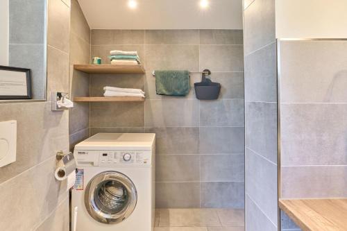 a laundry room with a washer and dryer at Liten Lycka in Simonsberg