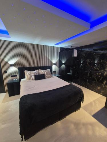 a bedroom with a large bed with blue lighting at Hotel Broer & Zus in The Hague