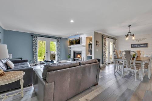 a living room with a couch and a dining room at FLAT Lakefront Home w/ Dock-Kayaks-Paddle Board in Sandlick
