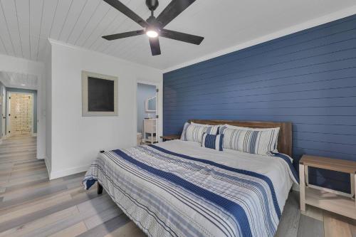 a bedroom with a bed with a blue wall at FLAT Lakefront Home w/ Dock-Kayaks-Paddle Board in Sandlick