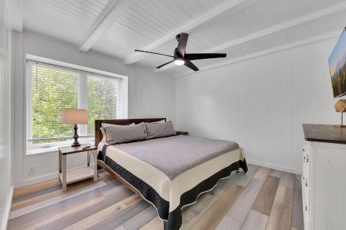 a bedroom with a bed and a ceiling fan at FLAT Lakefront Home w/ Dock-Kayaks-Paddle Board in Sandlick