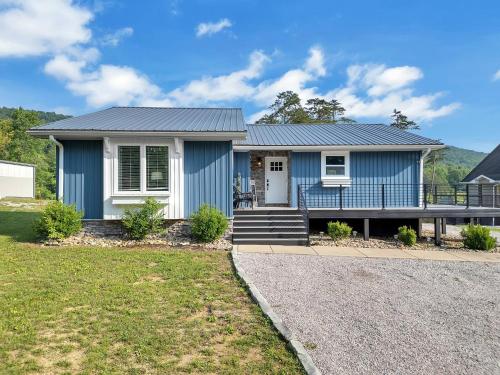 a blue and white house with a porch at FLAT Lakefront Home w/ Dock-Kayaks-Paddle Board in Sandlick