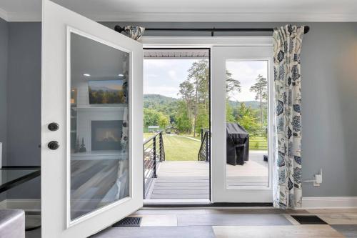 an open door leading to a dining room with a table at FLAT Lakefront Home w/ Dock-Kayaks-Paddle Board in Sandlick