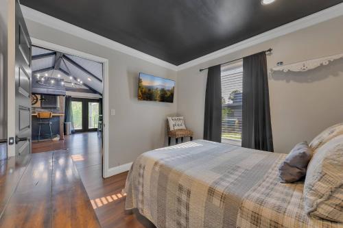 a bedroom with a bed and a large window at FLAT Lakefront Home w/ Dock-Kayaks-Paddle Board in Sandlick