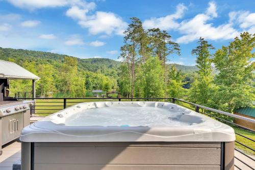 a jacuzzi tub on the balcony of a house at FLAT Lakefront Home w/ Dock-Kayaks-Paddle Board in Sandlick