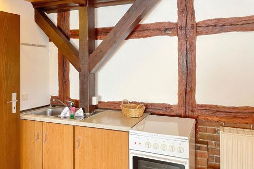 a kitchen with a sink and a stove at Efeu Altstadtflair in Lübbenau