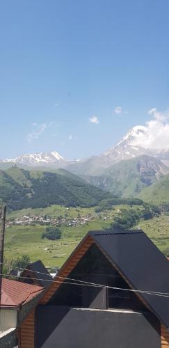 a view of a mountain range with snow covered mountains at Elnetsa Inn Kazbegi in Stepantsminda