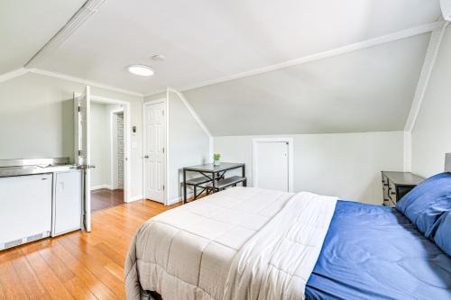 a bedroom with a bed and a kitchen at Long Island Duplex By Airport and Train in Valley Stream