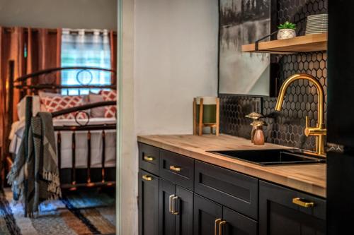 a kitchen with a sink and a bed in a room at North 40 Lodge and Cabin in Clarkesville