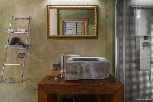 a bathroom with a sink and a mirror on the wall at Palazzo d'Assi - Guest house in Monforte dʼAlba