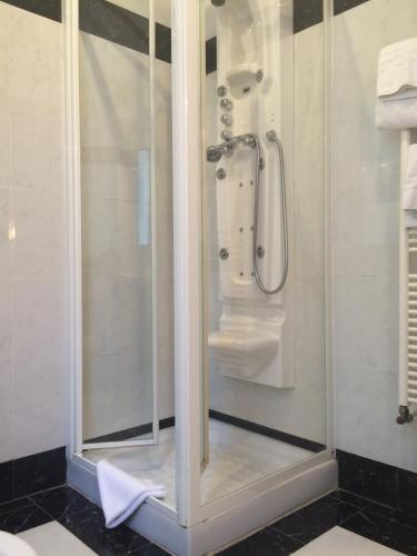 a shower with a glass door in a bathroom at Al Teatro in Livorno