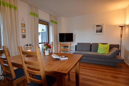 a living room with a table and a couch at Seeluft in Chieming