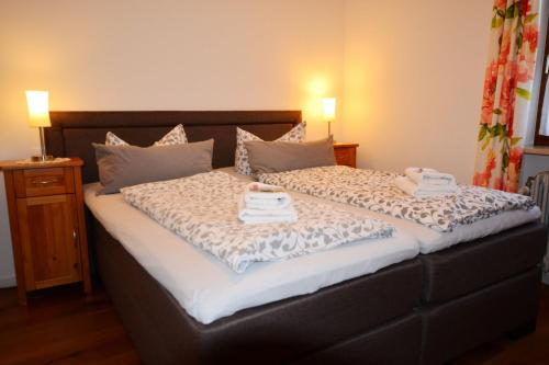 a bedroom with a bed with two towels on it at Seeluft in Chieming