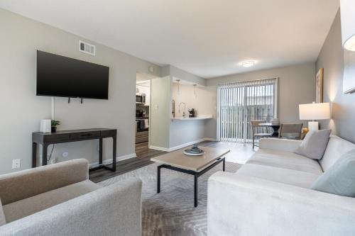 a living room with a couch and a tv at Landing Apartments - Castleton in Indianapolis
