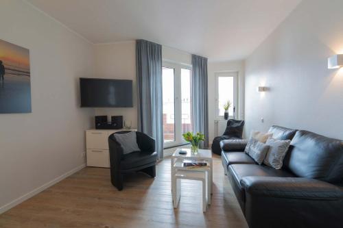 a living room with a couch and a table at MaJa in Norderney