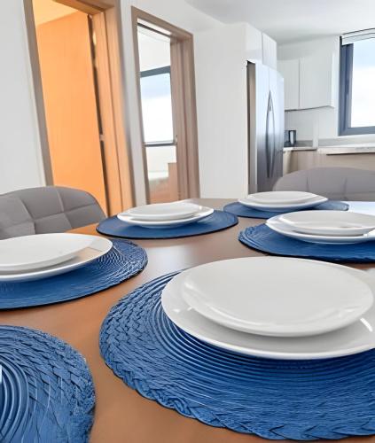 a table with blue and white plates on it at Alojamiento con playa artificial en el centro de la ciudad in Higuey