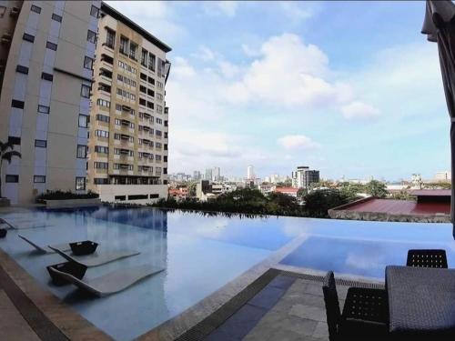 a swimming pool with a view of a building at Persimmons Mabolo, Cebu City in Cebu City