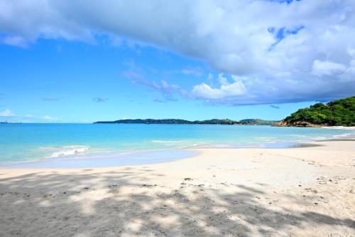 a view of the beach on a sunny day at Hummingbird Villa in Saint Johnʼs