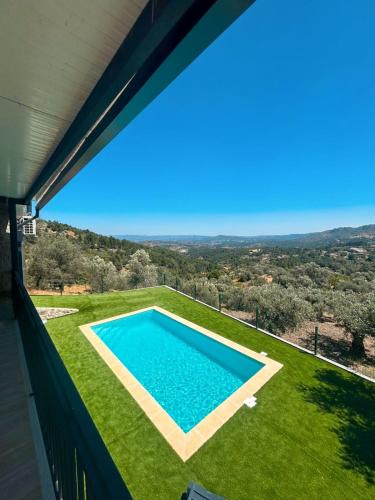 a view of a swimming pool from the balcony of a house at Casas Chão da Roseira in Celorico da Beira