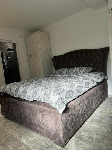 a bedroom with a large bed with a brown bedspread at Perfect place 4 Djenovici in Đenovići
