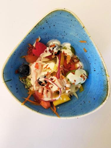 a blue plate of food on a white table at T'AMI Hotel Resort Spa in Selvino