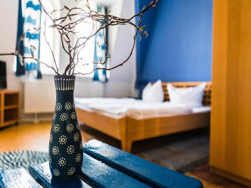 a blue vase sitting on a table in a room at Gut Boltenhof in Fürstenberg-Havel