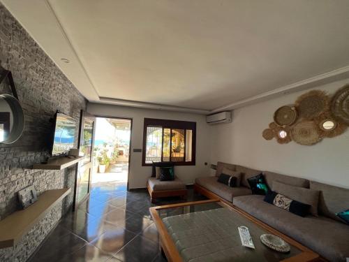 a living room with a couch and a table at House near beach in M'diq