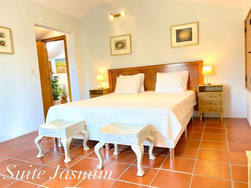 a bedroom in a villa with a large bed at Casa Raiz Guest House & Retiro in Ferreira do Zêzere