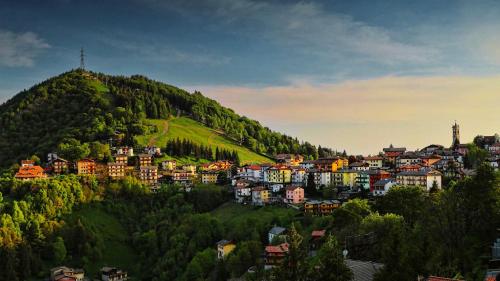 a town on top of a green hill at T'AMI Hotel Resort Spa in Selvino