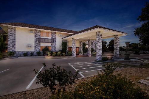 a rendering of a hotel with a parking lot at HomeTowne Studios by Red Roof Ridgecrest in Ridgecrest