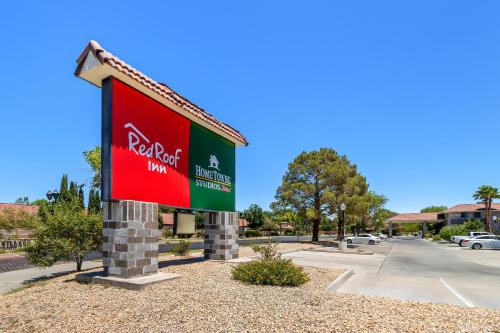 a sign for a hotel in a parking lot at HomeTowne Studios by Red Roof Ridgecrest in Ridgecrest
