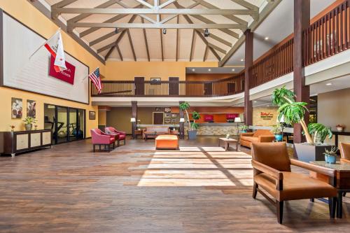 a lobby of a hospital with chairs and tables at HomeTowne Studios by Red Roof Ridgecrest in Ridgecrest