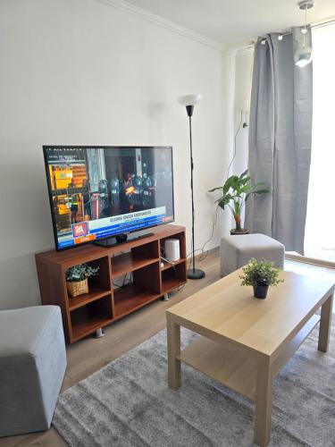 a living room with a television and a coffee table at Departamento Premium Full equipado in Rancagua