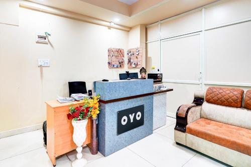 an office with a reception desk and a couch at Hotel O Sri Vishnu Prime Opposite The Studio Salon, Kundalhalli Gate in Bengaluru
