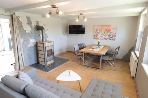 a living room with a couch and a table at Ferienhaus Schnitterkarten - nur an Feriengäste - ABC366 in Klütz